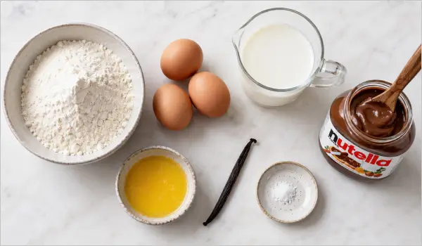 Ingrédients pour préparer des crêpes au Nutella maison : farine, œufs, lait, beurre et Nutella